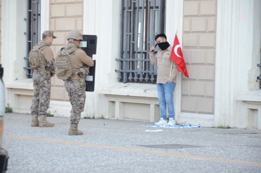 İZMİR’DE YERE ATTIĞI İSRAİL BAYRAĞININ ÜZERİNE BASAN PAKİSTAN UYRUKLU BİR KİŞİ KAFASINA SİLAH DAYAYARAK EYLEM YAPTI
